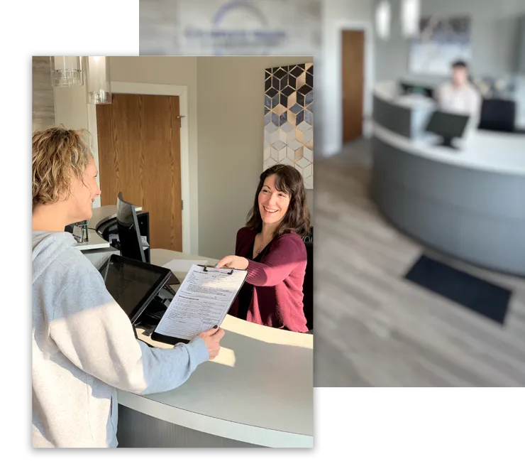 Chiropractic Hartland WI Corrie Helping Patient At Front Desk